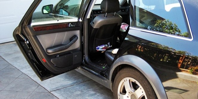 CLICK to continue: Black car with door open